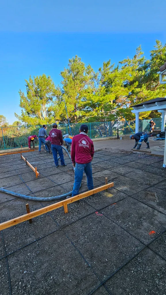 Action shot of a construction crew pouring concrete