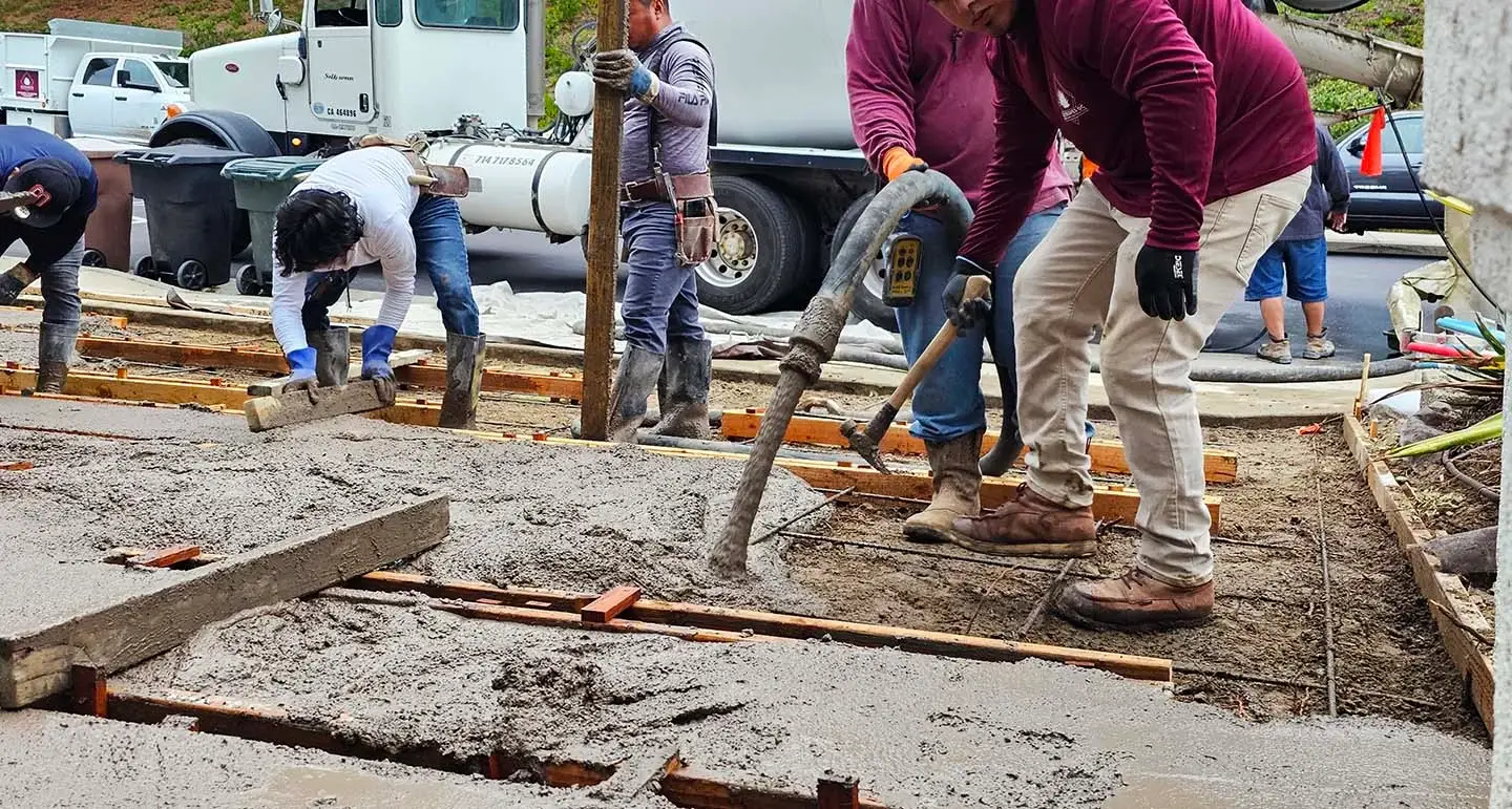 Action shot of a construction crew pouring concrete